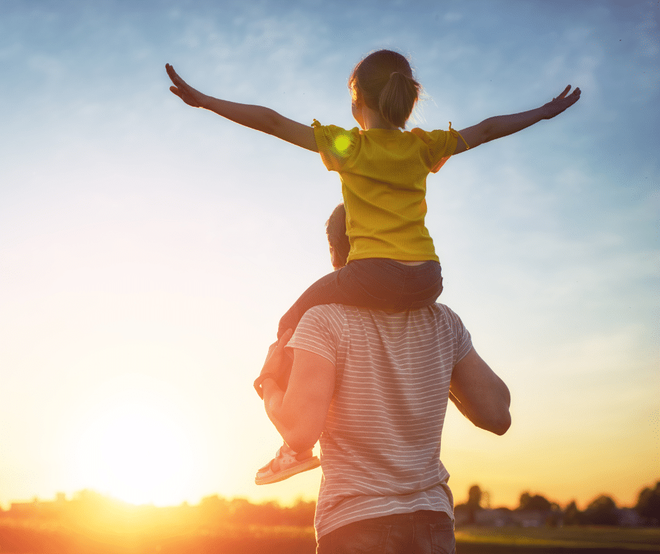 parent et enfant sous un coucher de soleil