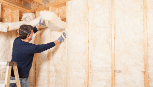 homme qui isole un mur par l'intérieur